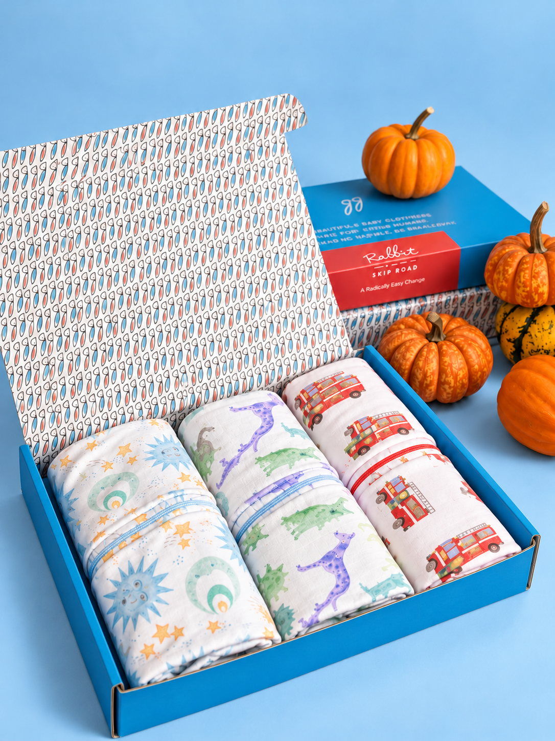 Three organic cotton jumpers in a blue Rabbit Skip Road gift box